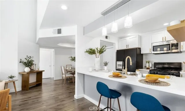 a kitchen with a sink cabinets and wooden floor