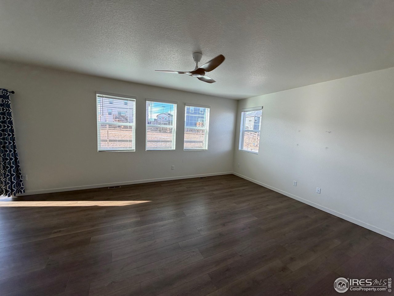 107 65th Avenue Greeley, CO 80634 - Photo 11 of 38 Living room with LVT flooring and remove controlled fan.