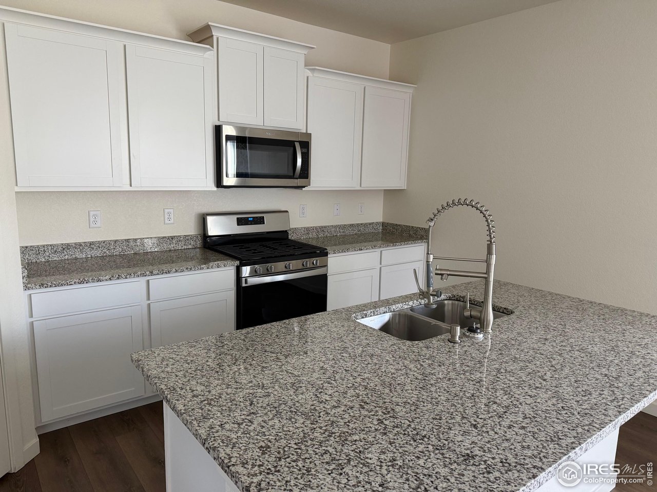 107 65th Avenue Greeley, CO 80634 - Photo 3 of 38 Kitchen with granite countertop and island