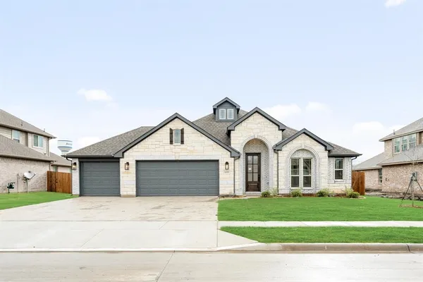 a front view of a house with a garden and garage
