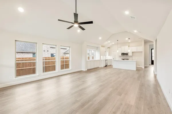 a living room with lots of furniture and a large window
