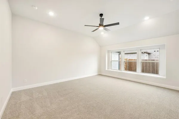 a bedroom with a bed a couch and a large window