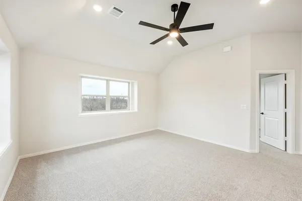 an empty room with a window and a fan