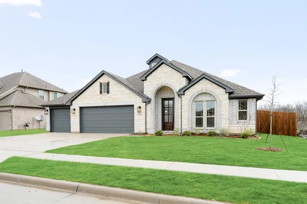 a view of a white house with a yard and large trees