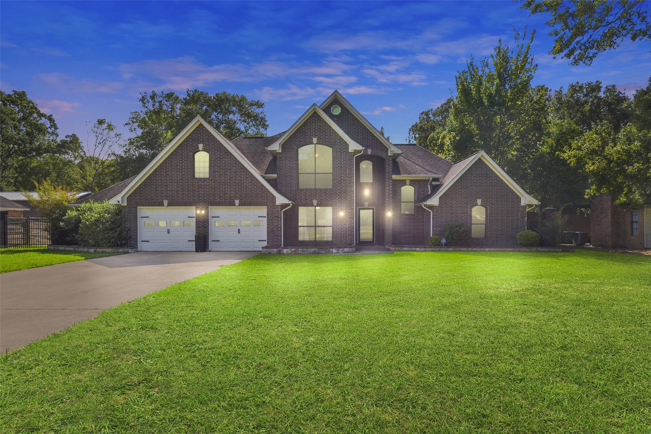 a front view of house with yard and green space