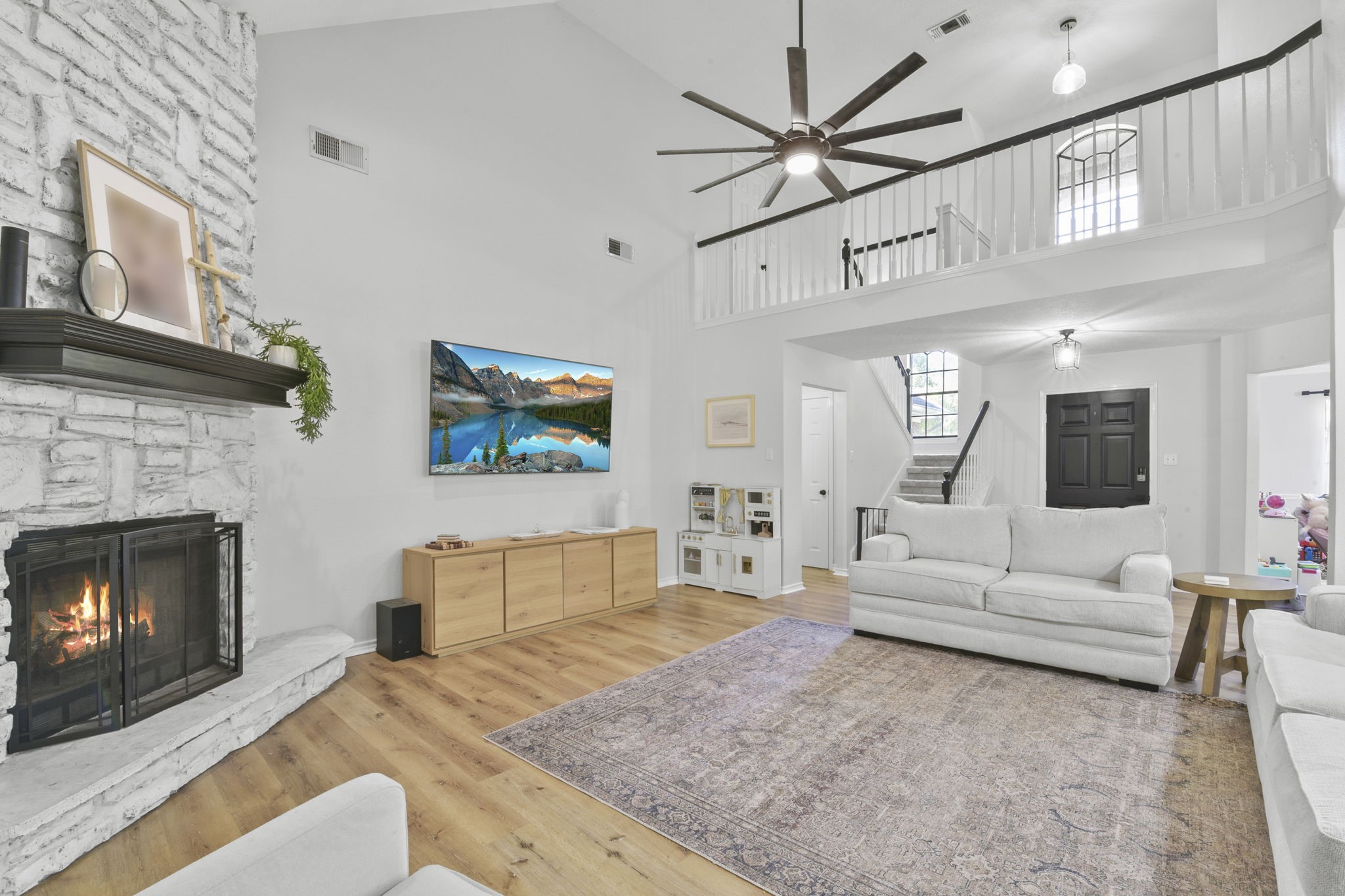 223 Oetken West Road Anahuac, TX 77514 - Photo 12 of 50 a living room with furniture a fireplace and a flat screen tv