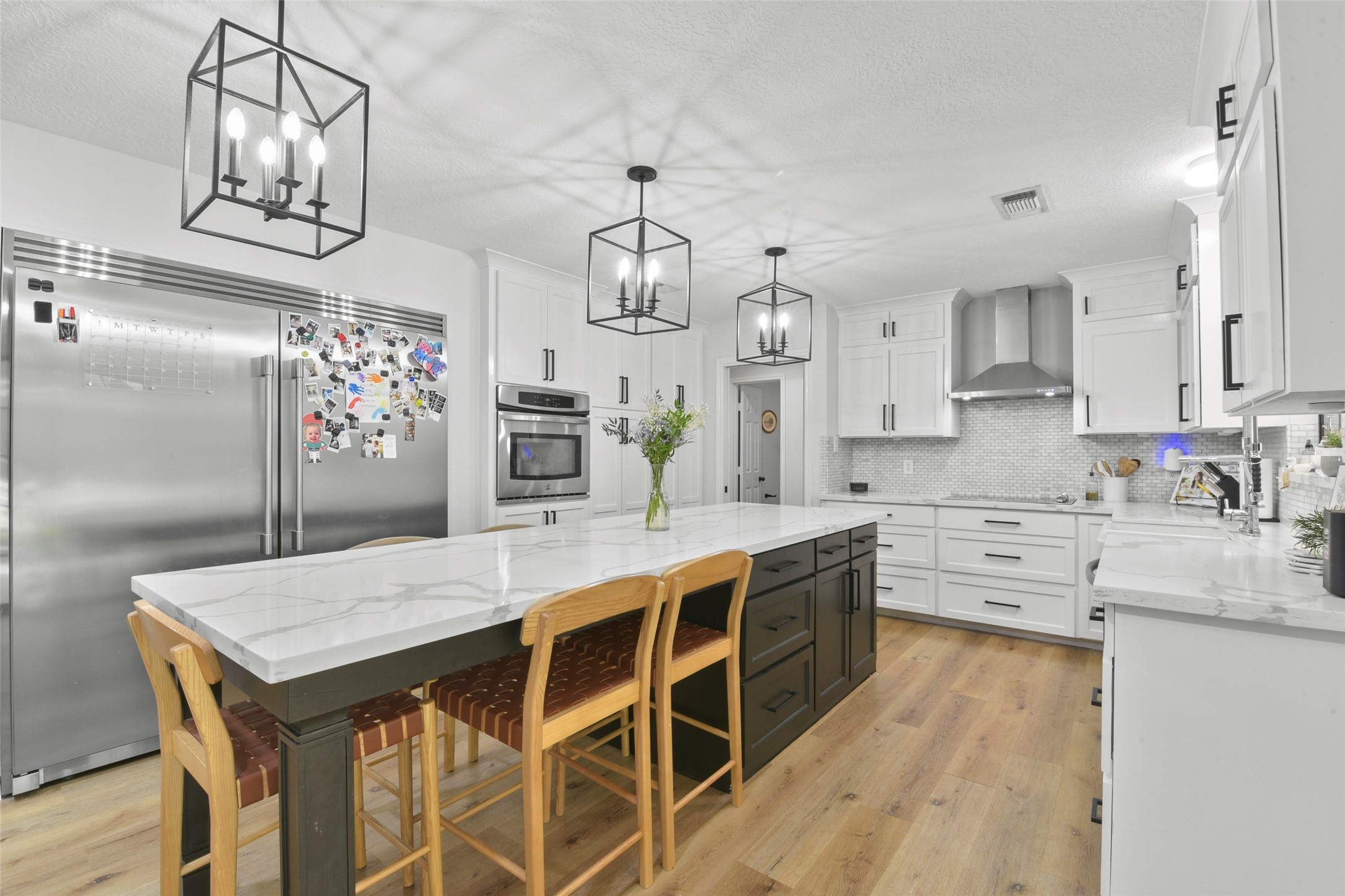 223 Oetken West Road Anahuac, TX 77514 - Photo 16 of 50 a kitchen with stainless steel appliances granite countertop a kitchen island a stove a table and chairs in it