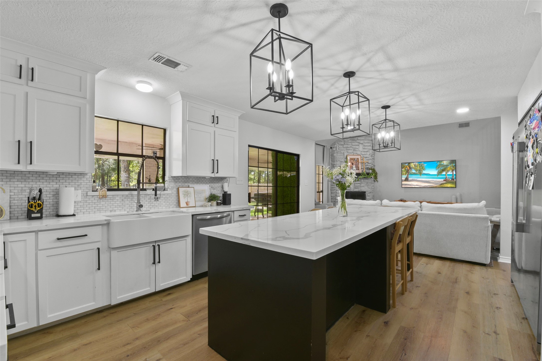 223 Oetken West Road Anahuac, TX 77514 - Photo 19 of 50 a kitchen with counter top space sink stove and wooden floor