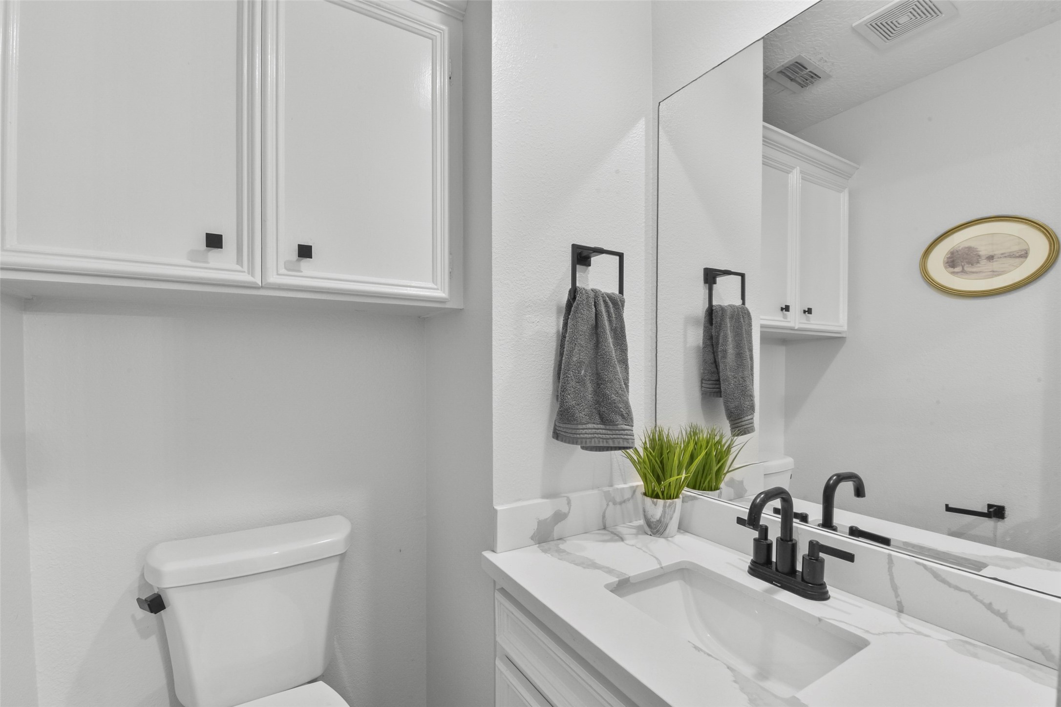 223 Oetken West Road Anahuac, TX 77514 - Photo 20 of 50 a bathroom with double sink and a mirror