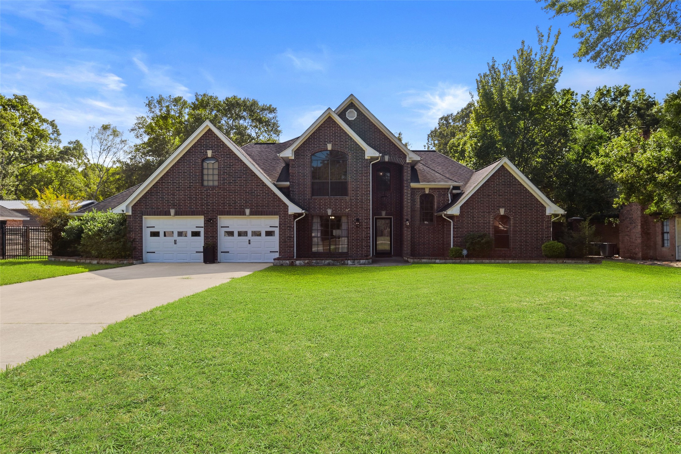 223 Oetken West Road Anahuac, TX 77514 - Photo 2 of 50 a front view of a house with garden