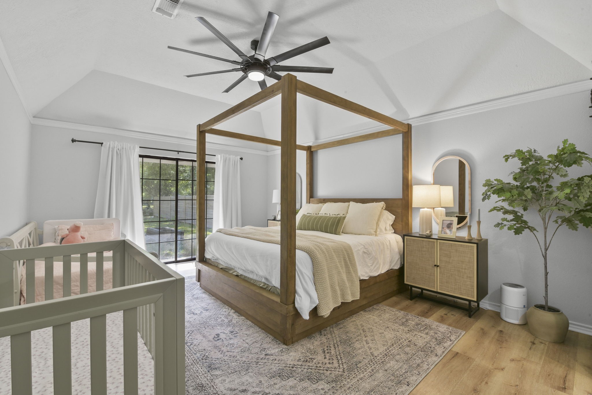 223 Oetken West Road Anahuac, TX 77514 - Photo 23 of 50 a bedroom with a bed and a chandelier