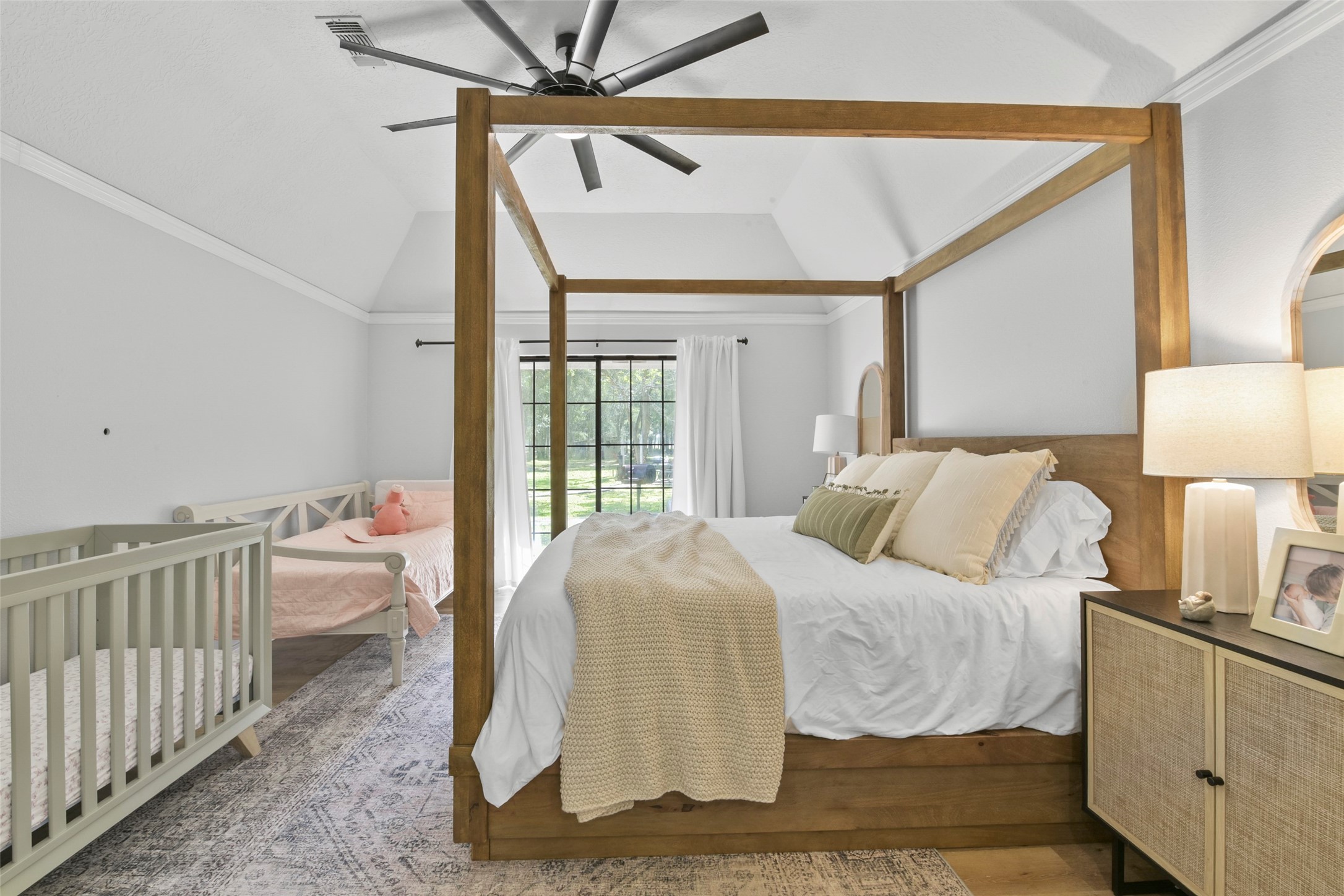 223 Oetken West Road Anahuac, TX 77514 - Photo 24 of 50 a bedroom with a bed and a chandelier