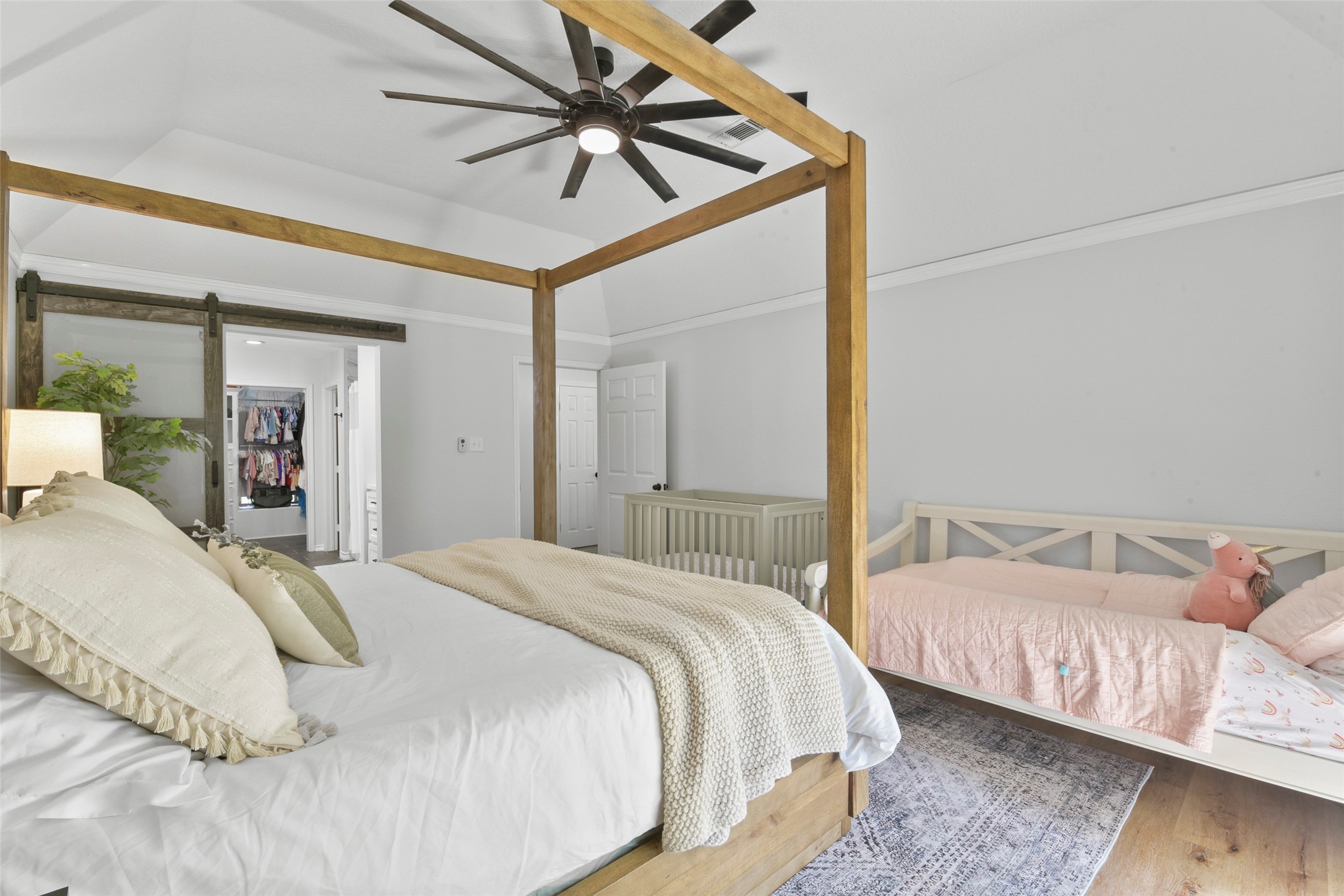 223 Oetken West Road Anahuac, TX 77514 - Photo 25 of 50 a bedroom with beds and a chandelier