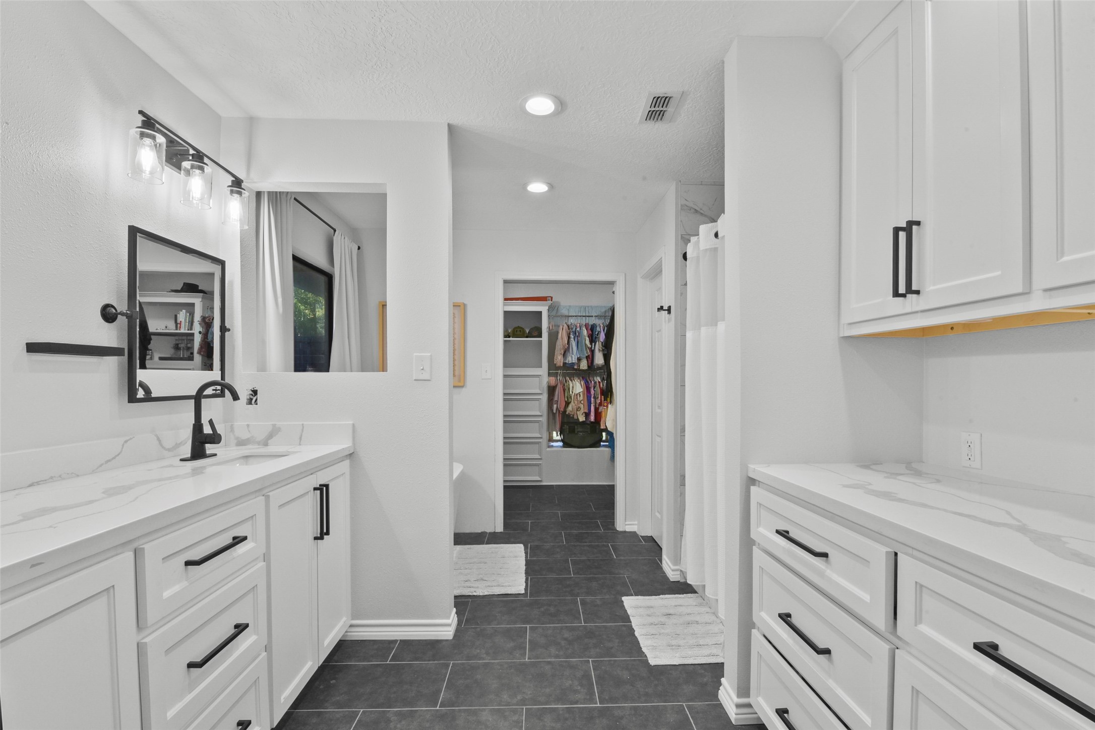 223 Oetken West Road Anahuac, TX 77514 - Photo 26 of 50 a spacious bathroom with a granite countertop sink a mirror and shower