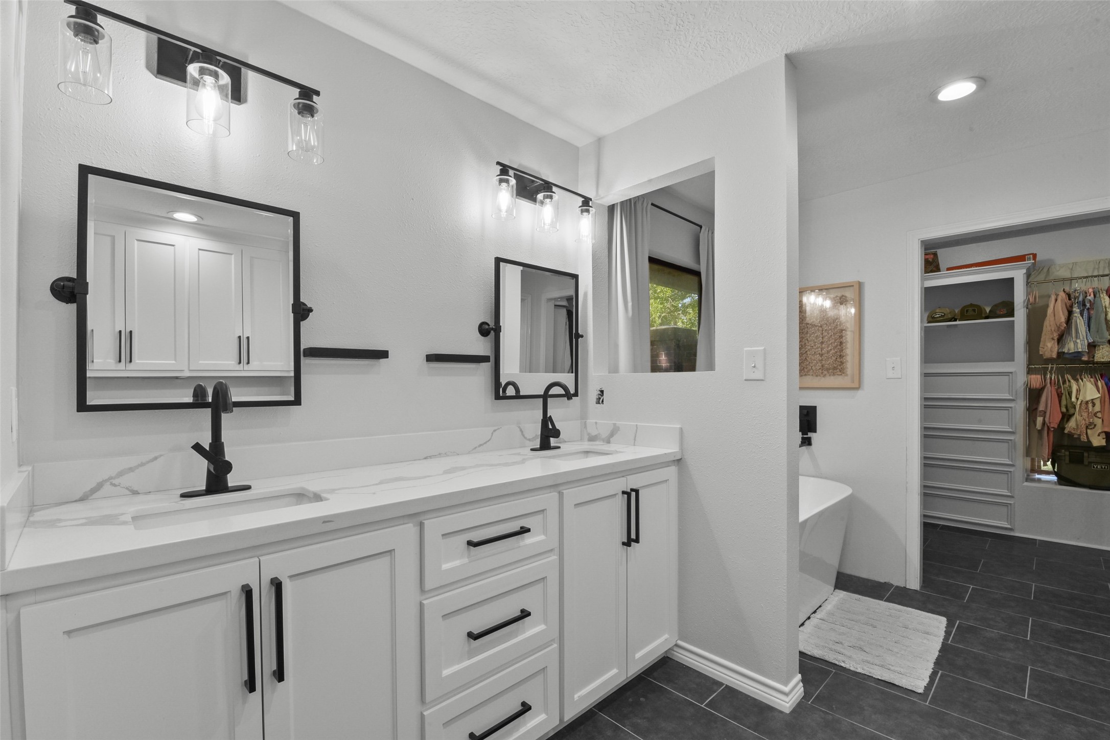 223 Oetken West Road Anahuac, TX 77514 - Photo 27 of 50 a bathroom with a double vanity sink and a mirror