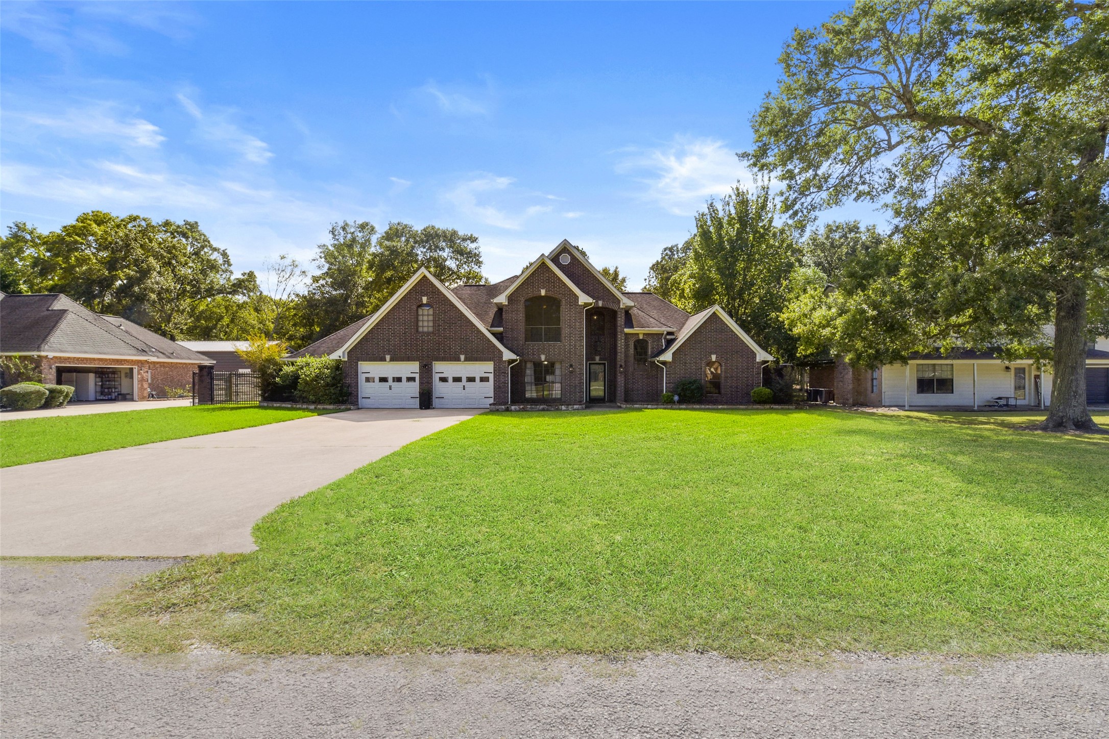 223 Oetken West Road Anahuac, TX 77514 - Photo 3 of 50 a view of house with garden and tall trees