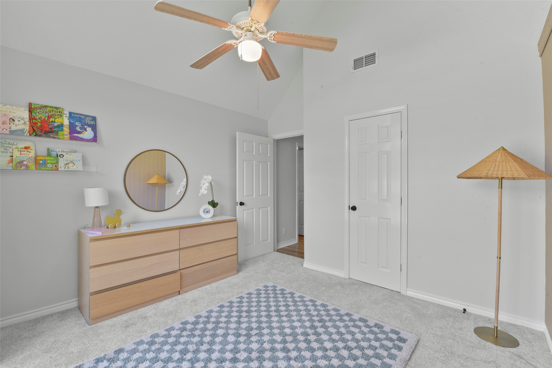 223 Oetken West Road Anahuac, TX 77514 - Photo 33 of 50 a room with a baby bed and a chandelier