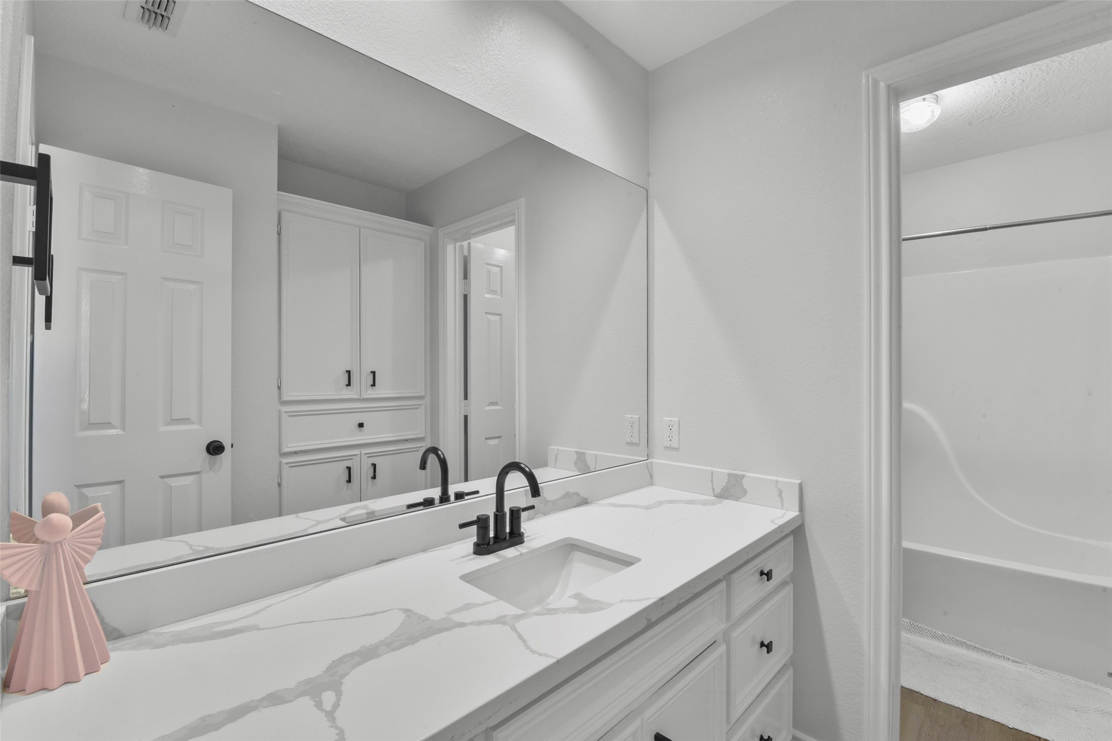223 Oetken West Road Anahuac, TX 77514 - Photo 34 of 50 a bathroom with a granite countertop sink and a mirror