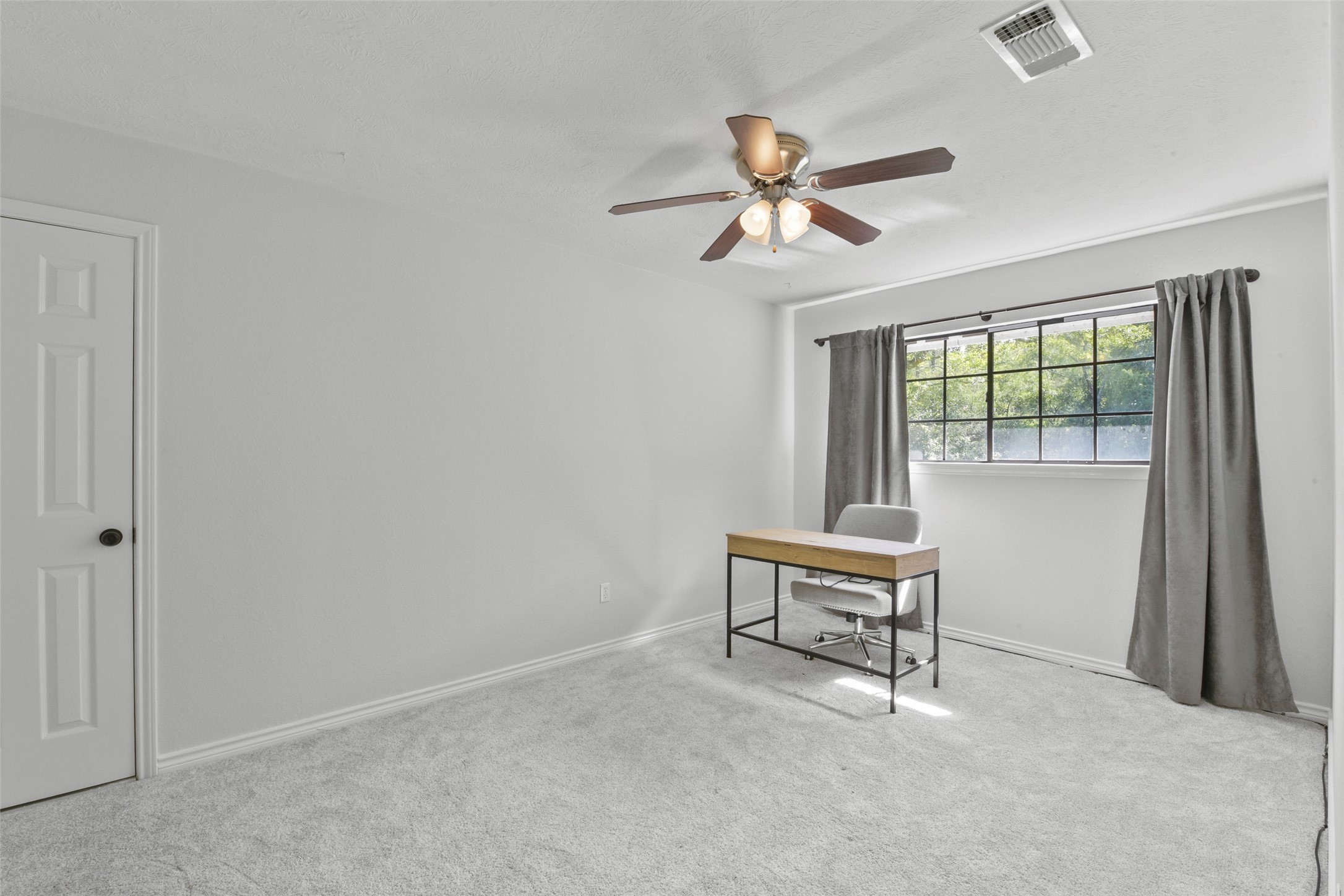 223 Oetken West Road Anahuac, TX 77514 - Photo 36 of 50 a bedroom with a bed and a window