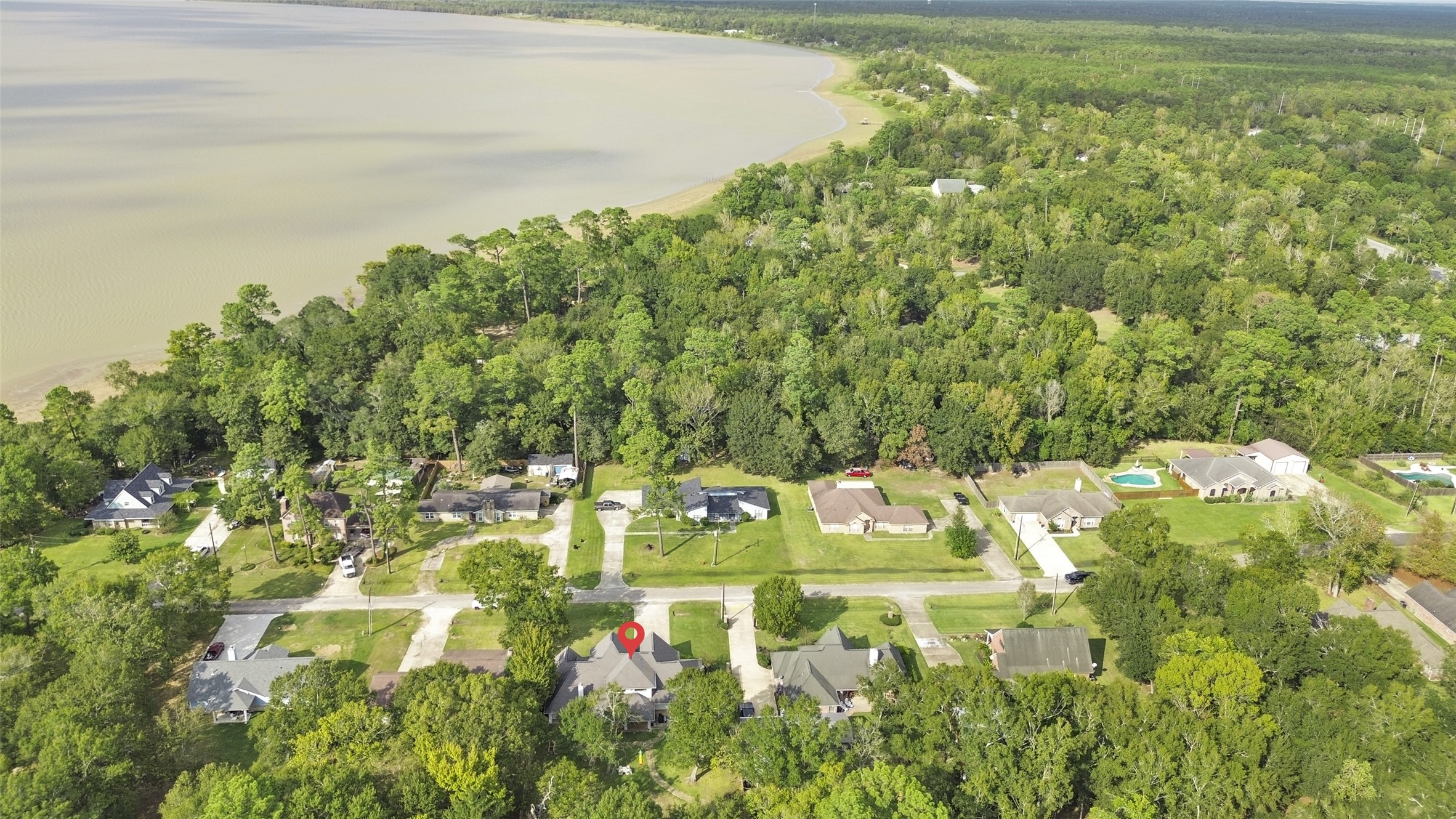 223 Oetken West Road Anahuac, TX 77514 - Photo 48 of 50 a bathroom with a sink and green landscape