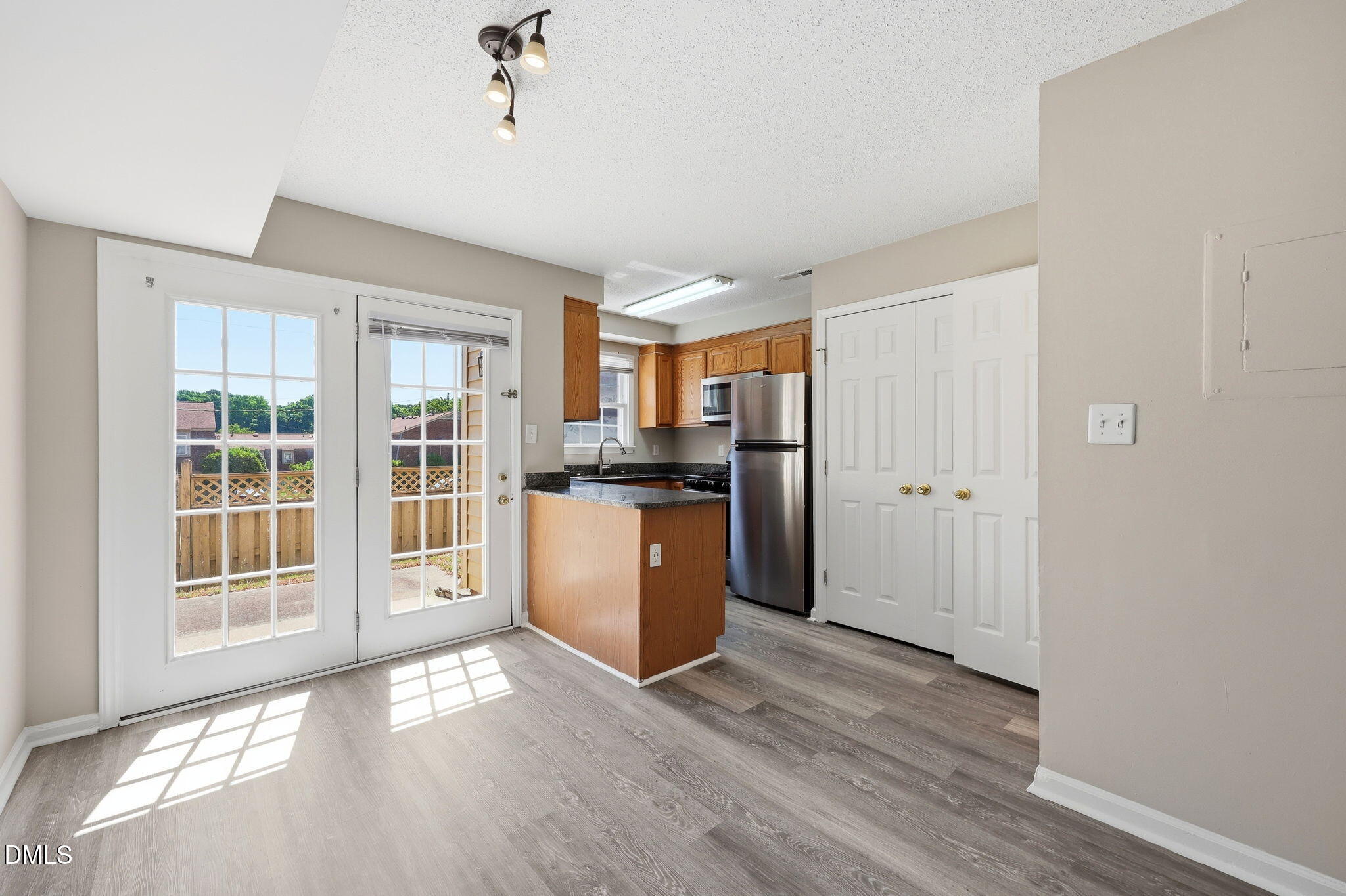 145 Jones Franklin Road, Unit D Raleigh, NC 27606 - Photo 5 of 23 a view of a kitchen with wooden floor and a kitchen