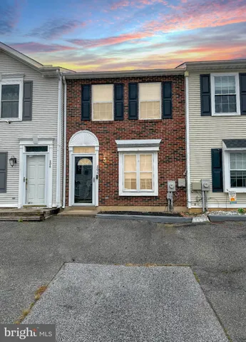 a front view of a house with a road