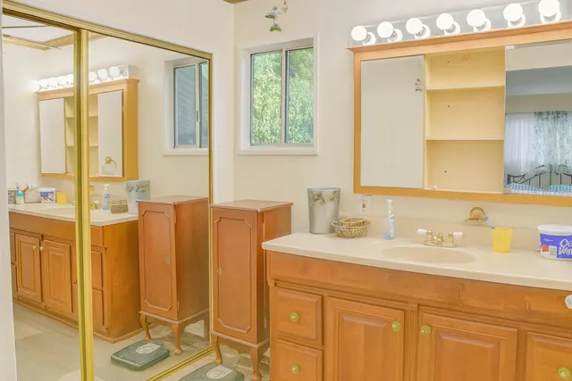 a bathroom with a granite countertop sink toilet and shower
