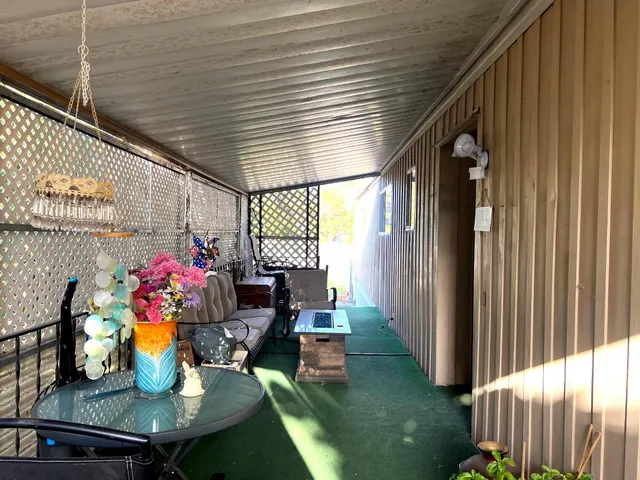 a view of balcony with wooden floor and furniture