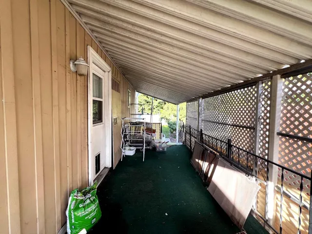 a view of a house with a large window and balcony