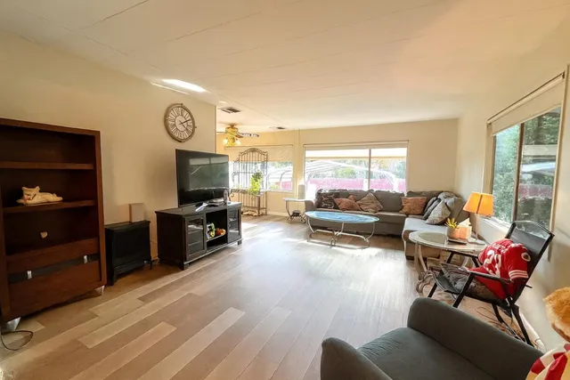 a living room with furniture and a large window