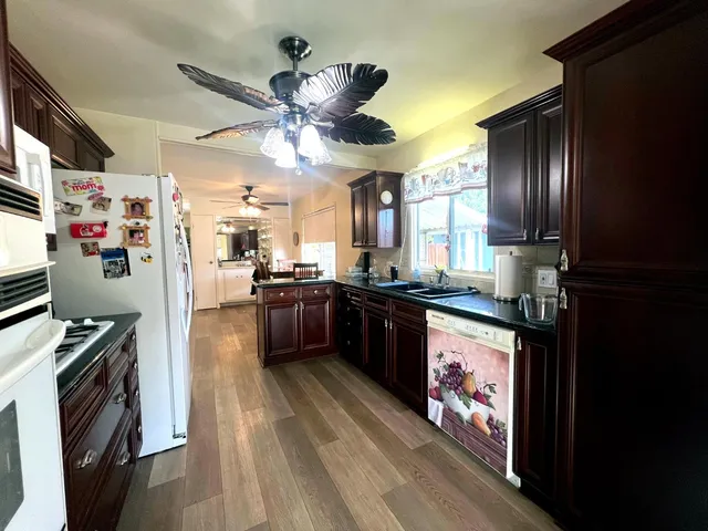 a kitchen with a sink a window and cabinets