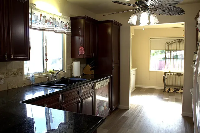 a view of a dining room with furniture and a chandelier