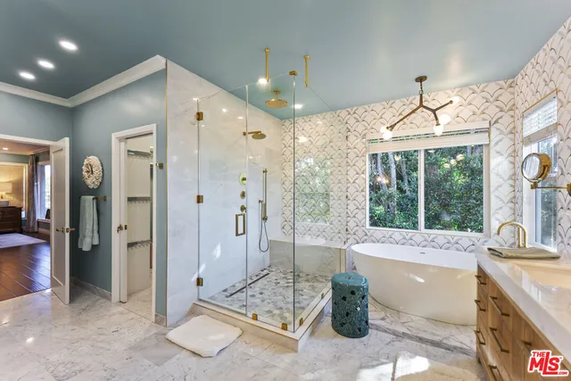 a spacious bathroom with a granite countertop tub shower and sink