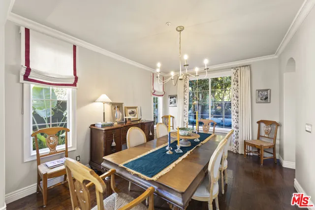 a view of a dining room with furniture a chandelier and wooden floor
