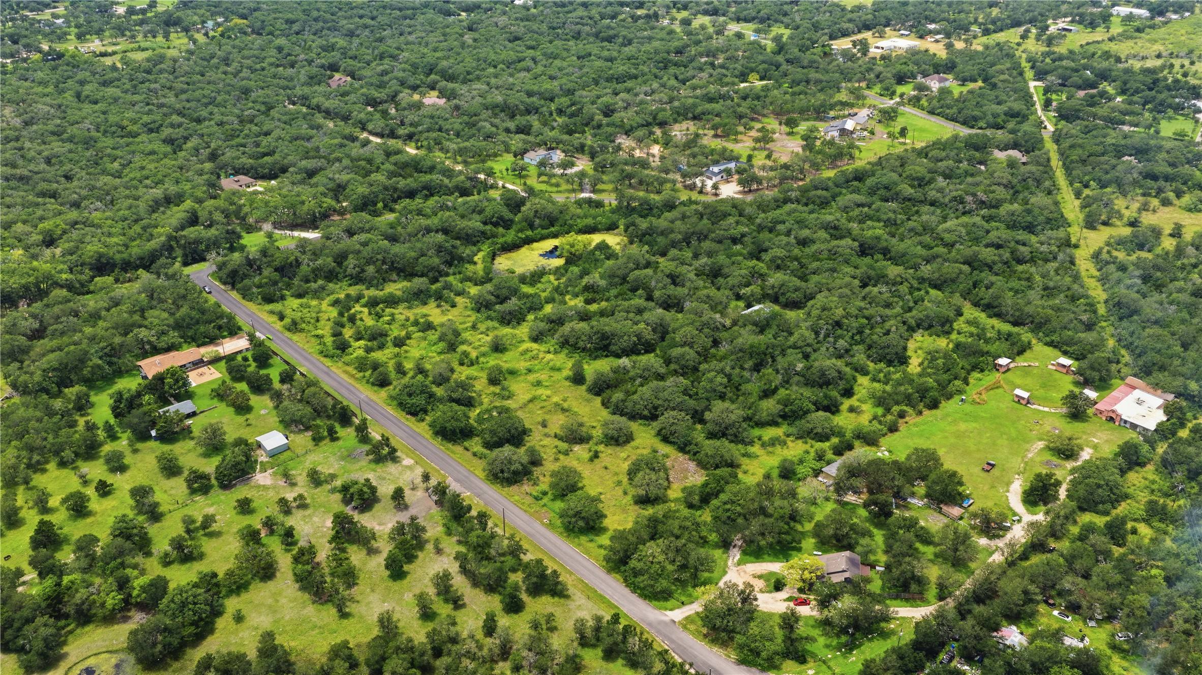 10312 Parsons Road Manor, TX 78653 - Photo 10 of 26 Vast, verdant landscape surrounds this rural property, offering serene privacy and ample space.