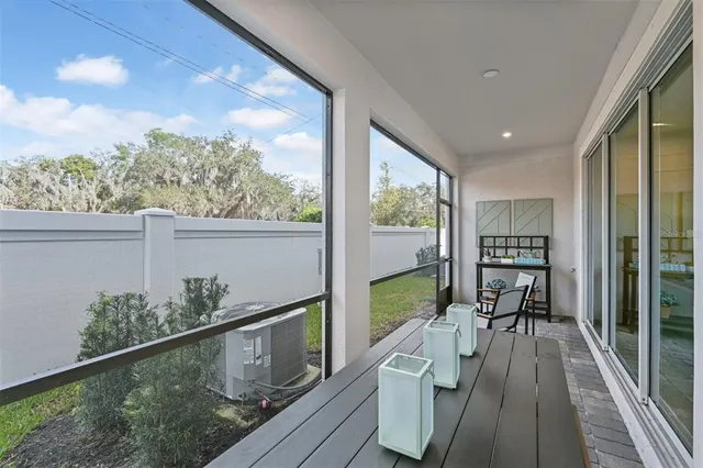 a view of a porch with furniture and garden