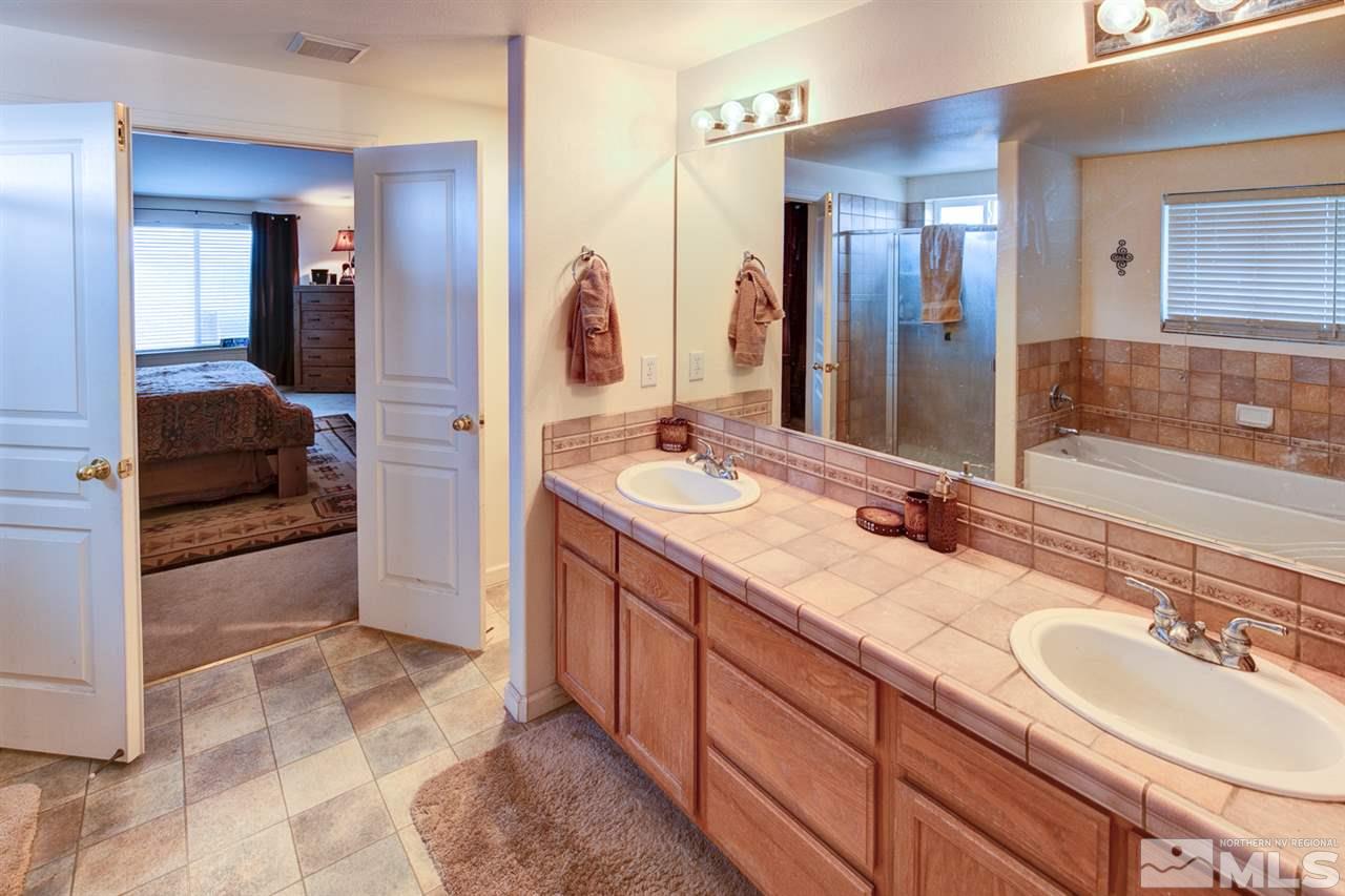 4363 Rancheria Road Fallon, NV 89406 - Photo 17 of 21 a en suite bathroom with a double vanity sink and a mirror