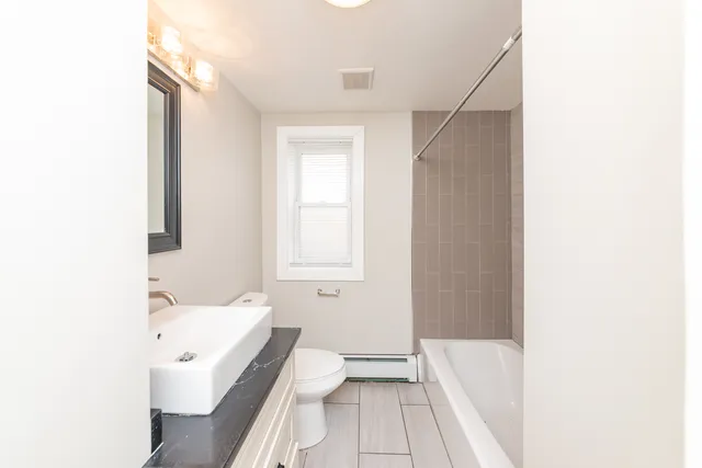 a bathroom with a sink a toilet and bathtub