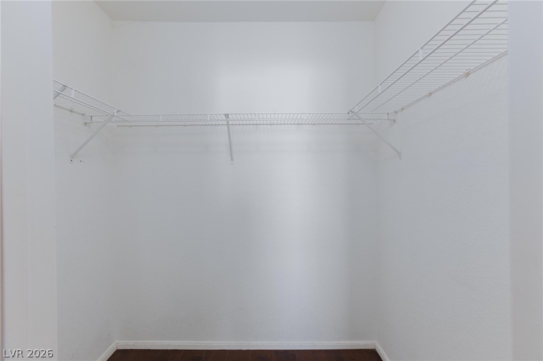 6650 West Warm Springs Road, Unit 2027 Las Vegas, NV 89118 - Photo 22 of 29 This spacious closet features practical wire shelving and rich hardwood flooring, ready for organization.