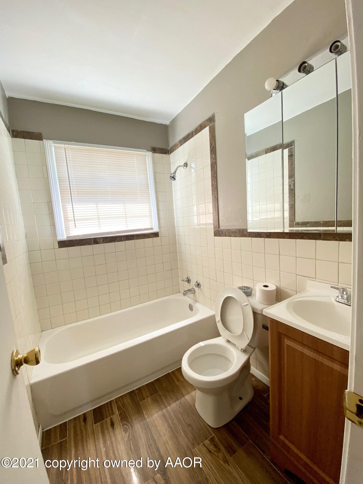 4008 South Monroe Street Amarillo, TX 79110 - Photo 8 of 9 a bathroom with a sink a toilet a mirror and bathtub