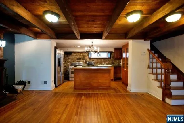 a view of a room with wooden floor