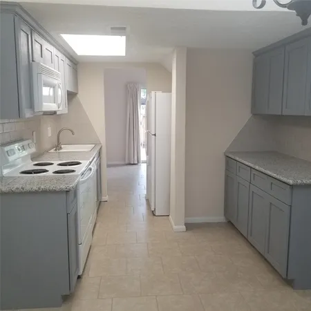a kitchen with a sink stove and cabinets
