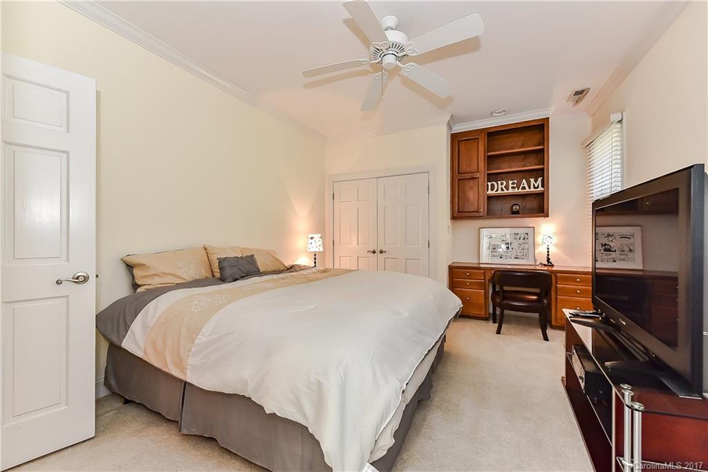 1621 Windy Ridge Road Charlotte, NC 28270 - Photo 14 of 24 a spacious bedroom with a bed a dresser and a chandelier