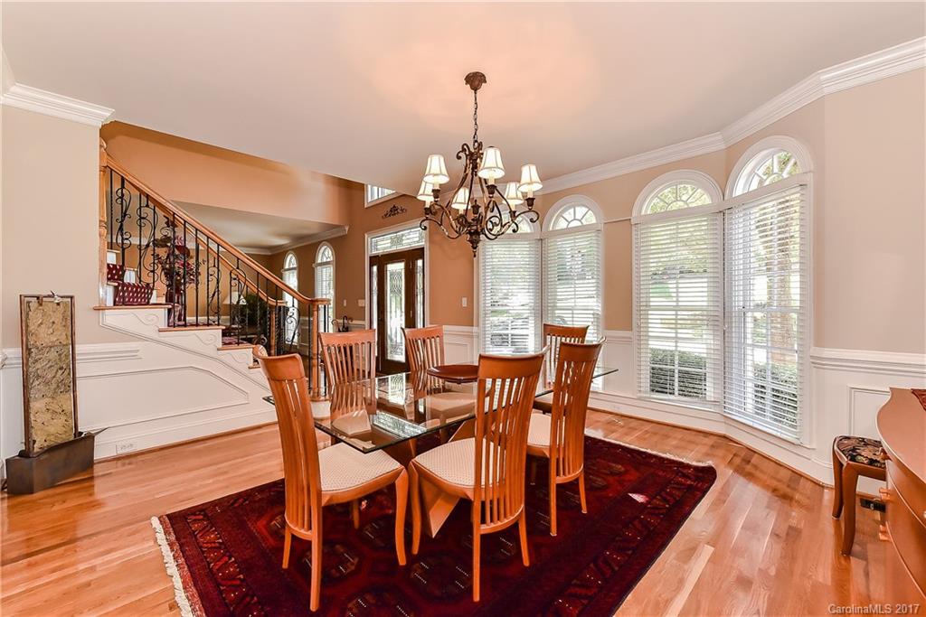 1621 Windy Ridge Road Charlotte, NC 28270 - Photo 3 of 24 a dining room with furniture a chandelier and wooden floor