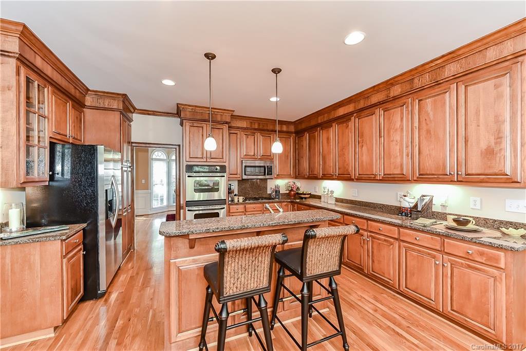 1621 Windy Ridge Road Charlotte, NC 28270 - Photo 8 of 24 a kitchen with stainless steel appliances a sink stove and refrigerator