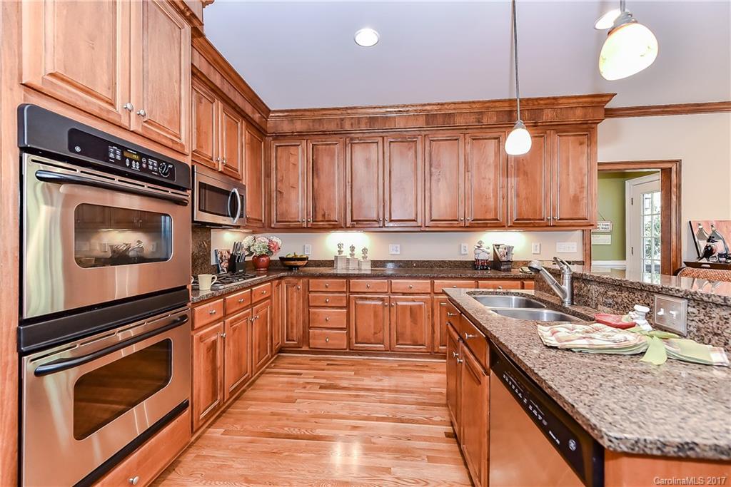 1621 Windy Ridge Road Charlotte, NC 28270 - Photo 9 of 24 a kitchen with granite countertop a sink stove and cabinets