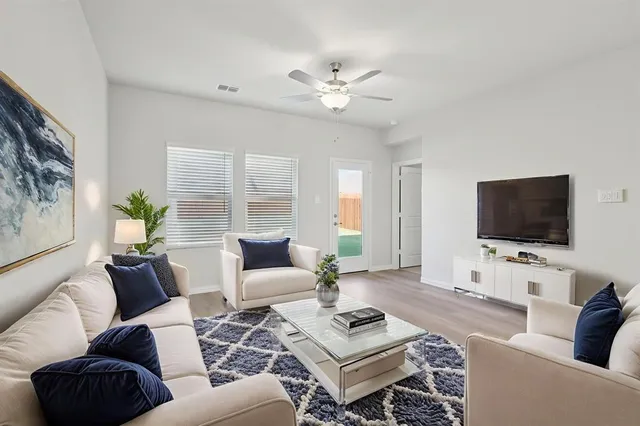a living room with furniture a rug and a flat screen tv