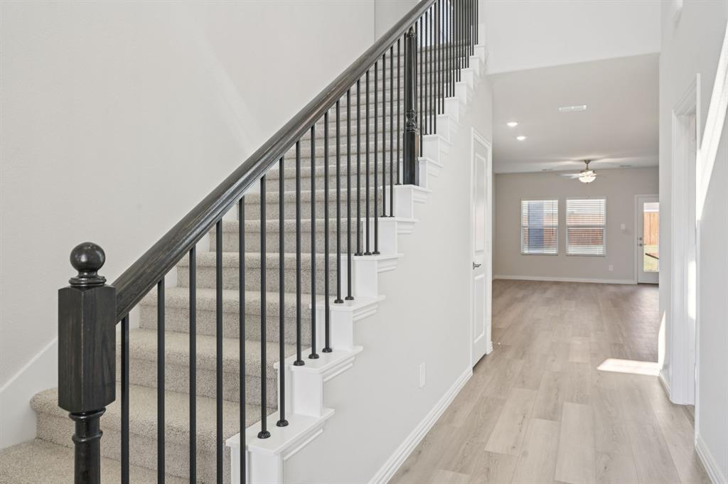 1720 Arches Road Anna, TX 75409 - Photo 14 of 31 a view of staircase with railing and white walls