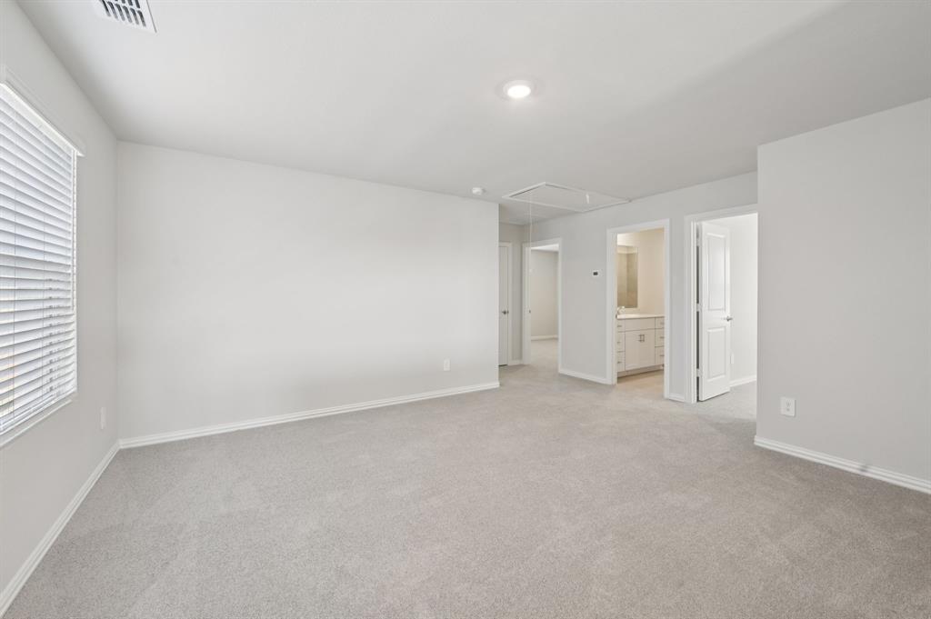 1720 Arches Road Anna, TX 75409 - Photo 21 of 31 an empty room with a window and a kitchen
