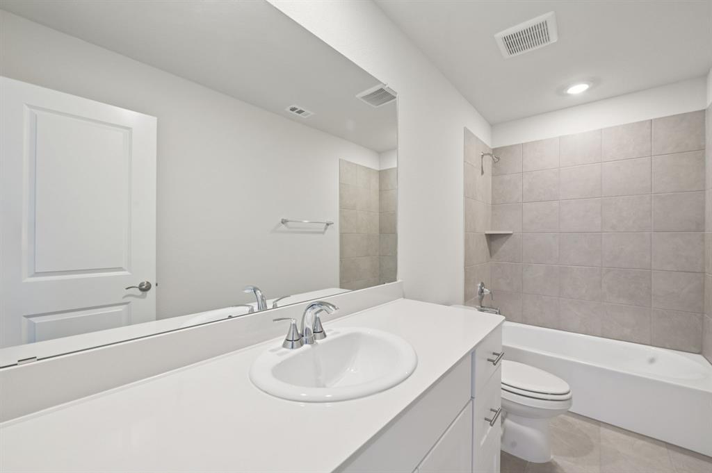 1720 Arches Road Anna, TX 75409 - Photo 26 of 31 a bathroom with a sink a toilet and shower